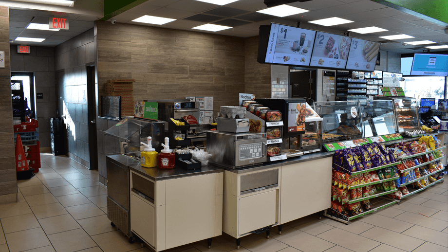 Indoor image of 7-11 showing the drinks fridges and sodas.