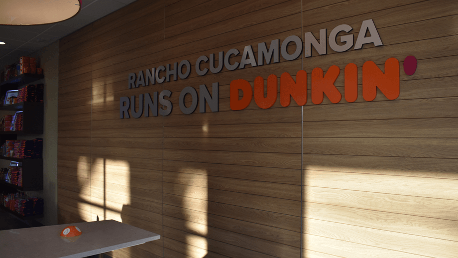 Indoor image of Dunkin Donuts showing the dining area's sign.