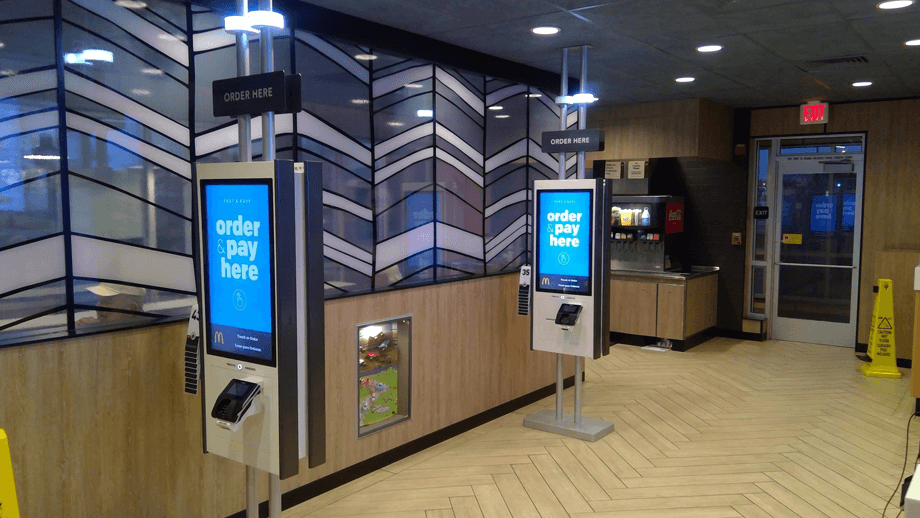 Indoor image of McDonalds showing the order kiosks.
