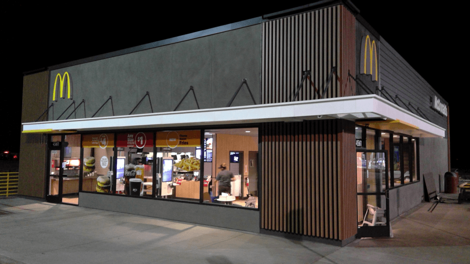 Outdoor image of McDonalds showing the main entrance at night.